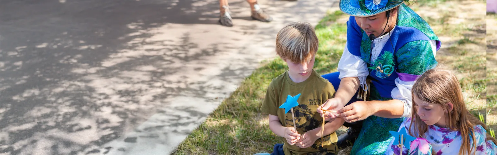 A Happily Ever Laughter craft leader guiding children through a group craft.