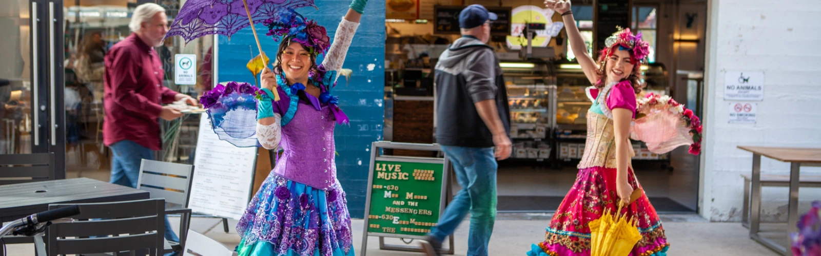 Costumed performers entertaining children at a restaurant family night.