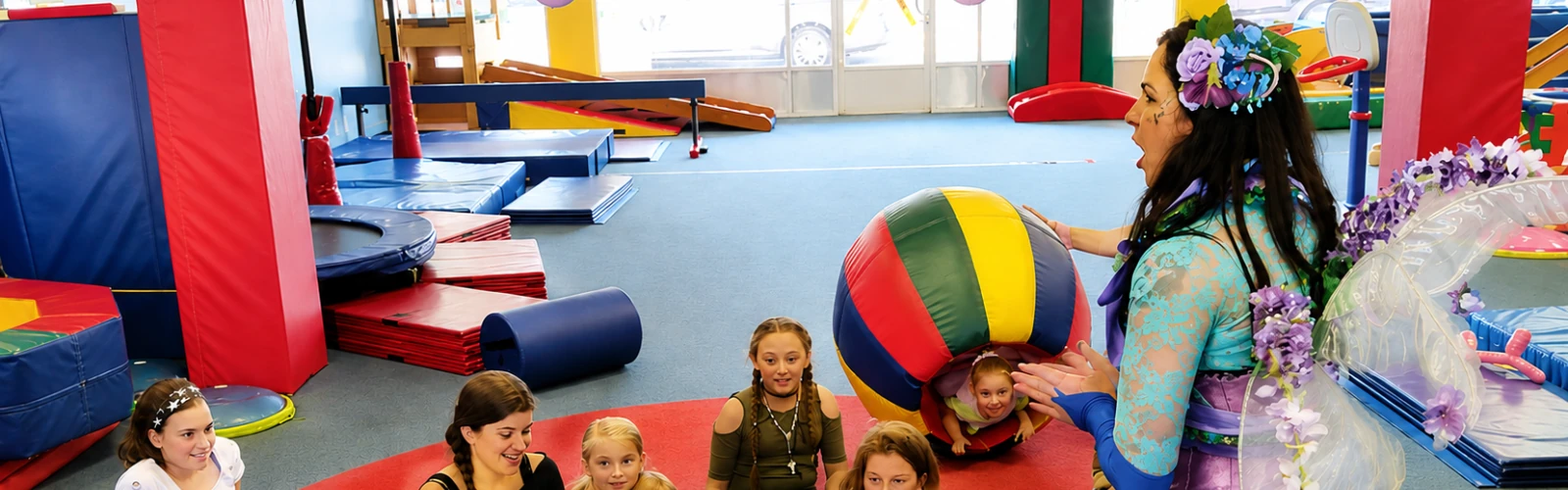Costumed performers leading games and activities for children at a school event.