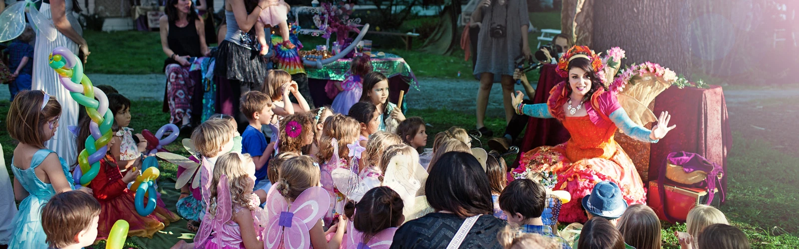 Costumed performers bringing activities to children at a summer camp.