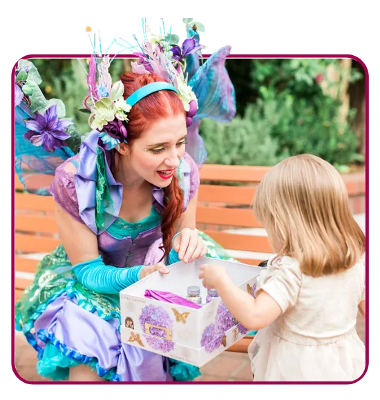 A Happily Ever Laughter craft leader roaming an outdoor party bringing crafts to children.